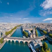 Paris aerial panorama with river Seine, Pont Neuf bridge, ile de la cite and Notre-Dame church, France. Holidays vacation destination. Panoramic view above historical Parisian buildings and landmarks.